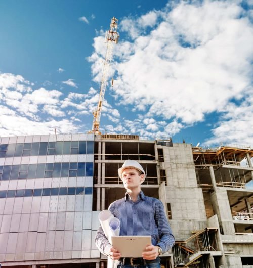 Construction manager controlling building site with plan